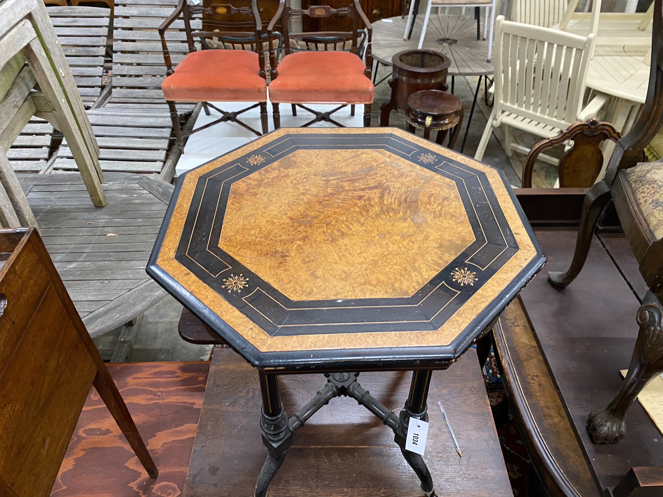 A late Victorian ebonised and amboyna octagonal centre table, width 56cm, height 64cm